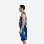 Side view of navy blue basketball uniform showing royal blue outer-leg shorts panel and white trim curve running from jersey to shorts hem