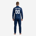 Close detail of navy soccer tracksuit jacket showing sky blue hexagon sublimation print and stand collar full-zip construction