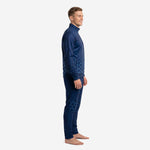 Navy soccer tracksuit side view showing hex sublimation pattern across jacket sleeve and tapered pant leg