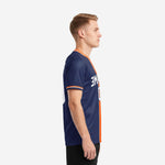 Left side view of a custom men soccer jersey showing navy blue body with orange vertical panel and white crew neck trim detail