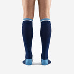 Close-up of sky blue and white double stripe ribbed cuff band on custom navy blue soccer socks
