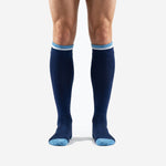 Front view of custom navy blue soccer socks with sky blue and white double stripe cuff band worn by adult male model