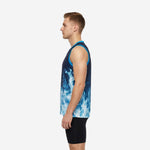 Left side view of navy and cyan basketball jersey showing straight hem length, wide armhole binding, and blue flame graphic wrapping the side panel