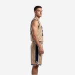 Side view of gold pinstripe basketball jersey and navy side panel shorts showing armhole binding and chevron hem detail