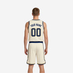 Opposite side view of the custom reversible basketball uniform highlighting cream side panel trim and navy contrast binding
