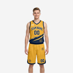 Gold side of the custom reversible basketball uniform set with gold jersey diagonal claw design navy trim and gold shorts with navy hem band