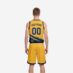 Side view of the gold and navy reversible basketball uniform showing reverse-side color layout and shorts side panel
