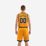 Side view of gold reversible basketball uniform showing hex pattern on lower shorts leg and gold armhole binding detail