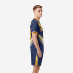 Custom navy and gold soccer team kit, side view showing gold panel detailing on jersey and shorts
