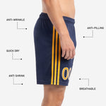 Athletic Gold player number with white outline sublimated on lower leg of custom navy blue soccer shorts, detail view