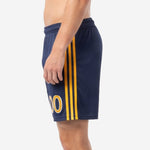 Navy blue soccer shorts with gold stripe side panel detail and sublimated player number, right side view on adult male model