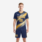 Top soccer uniforms in navy blue and gold with diagonal light-streak sublimation, front view, K2 Sportswear