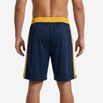 Back view of custom sublimated navy and gold basketball shorts showing back number print zone and notched side splits at hem
