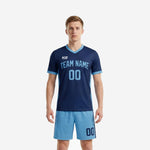 Men's custom blue soccer uniform front view showing navy V-neck jersey with light blue side panels and matching light blue shorts