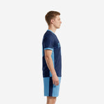 Custom blue soccer uniform left side view showing light blue contrast side panel running from underarm to hem on navy jersey