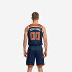 Other side view of navy and orange reversible basketball uniform showing the navy face with orange team name and number