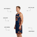Close-up of navy and orange reversible basketball shorts showing diagonal slash detail, drawcord waistband, and leg number