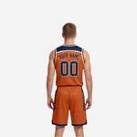 Side view of orange and navy reversible basketball jersey and shorts showing armhole binding and side panel graphic