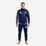 Front view of navy soccer tracksuit with hot pink floral printed sleeves and tapered pants on male model