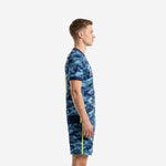 Side profile of custom blue soccer uniform set showing neon yellow side stripe on jersey and matching camo shorts