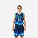 Custom navy youth basketball uniforms with blue flame sublimation pattern, cyan trim, team name and number on jersey and shorts - front and back view