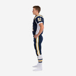 Side view of navy youth American football uniform showing white side panel on jersey and gold-bordered white stripe running down outer pant leg