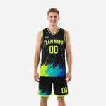 Custom neon green basketball uniforms in black with tribal pattern and paint-splash accents, front and back view showing team name and numbers