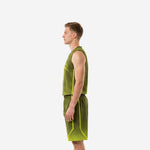 Side view of olive and neon green custom basketball uniform set showing geometric accent lines on shorts leg panel