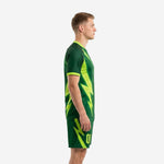 Men's neon green soccer uniform side view showing raglan sleeves and matching forest green shorts with neon green graphics