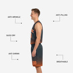 Orange and black reversible basketball shorts detail showing halftone dot pattern fading from charcoal into orange