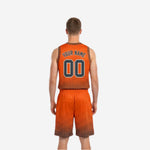 Orange and charcoal reversible basketball uniform side view showing V-neckline binding and shorts waistband construction