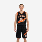 Orange and black reversible basketball uniforms showing black side front with diagonal orange slash graphic and matching shorts, worn by male model.