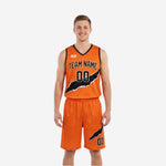 Reversible basketball uniform orange side front view showing orange jersey with black diagonal slash graphic and orange shorts with black slash detail.