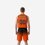 Opposite side view of orange and black custom reversible basketball uniform showing contrast binding and shorts gradient detail