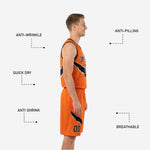 Close detail of orange and black reversible basketball shorts showing diagonal slash graphic on right leg and sublimated player number below.