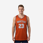 Custom orange basketball jerseys with navy side panels, V-neck trim, arched team name and number 23 on front and back