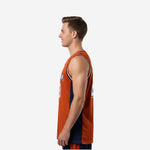 Side view of orange custom basketball jersey showing navy side panel construction and armhole binding detail