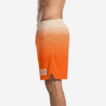 Side view of orange hex fade basketball shorts showing wide elastic waistband, mid-thigh length, and side split at hem