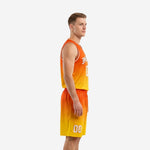 Side view of the orange basketball uniform showing the clean gradient fade from orange waistband to gold hem on the matching shorts