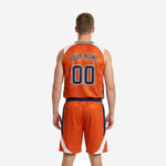 Opposite side view of sublimated orange basketball uniform displaying the white and navy panel detail running from jersey through the shorts