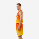 Left side view of the custom orange and gold sublimated basketball jersey and shorts set showing armhole binding and side panel construction