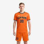 Orange and black custom kits soccer uniform front view with team name and number