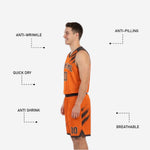 Close-up of matching basketball shorts with elastic drawcord waistband and orange trim hem on the charcoal side