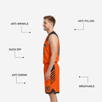 Close-up detail of sublimated slash stripe panel on orange and black reversible basketball jersey showing colorfast print quality