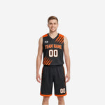 Custom orange and black reversible basketball uniforms showing black front side and orange reverse side with slash stripe panels and matching shorts