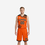 Front view of custom orange and black reversible basketball uniforms with diagonal slash stripes across chest and shorts side panels