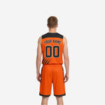 Opposite side view of custom reversible basketball uniform in orange and black with matching hem band on shorts