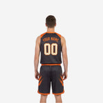 Side view of orange and black reversible basketball uniform showing armhole binding and athletic cut sleeveless jersey