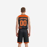 Side view of orange and black reversible basketball uniform showing armhole binding and shorts side panel trim