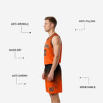 Close-up detail of sublimated hexagon pattern on black and orange reversible basketball jersey and shorts